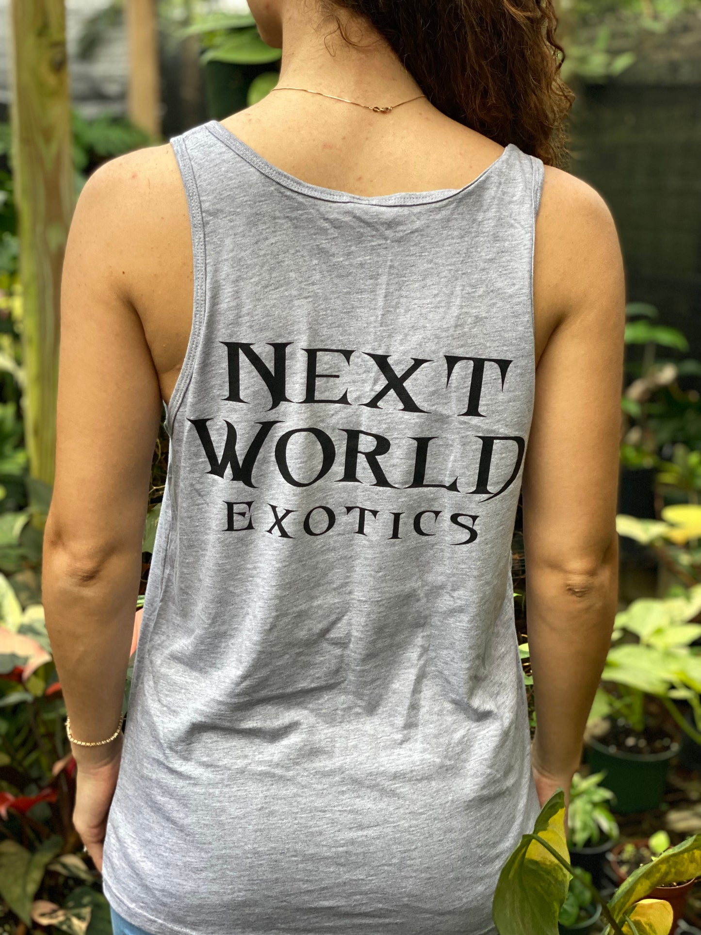 Woman wearing a gray tank top with black botanical floral monogram logo by Ashley Simone.