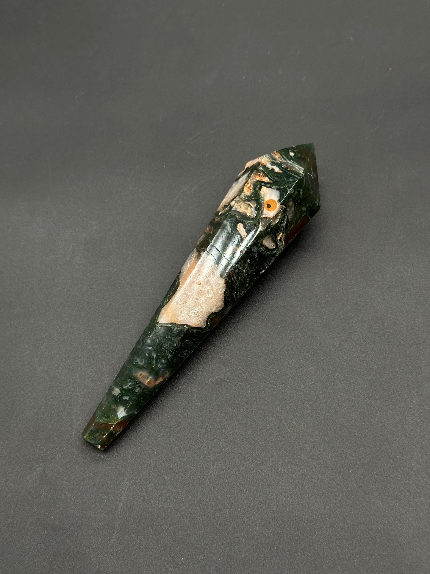 Red Moss Agate Scepter (812W12), a polished, faceted stone wand shaped as a hexagonal prism with a pointed tip, showcasing mottled jasper patterns.