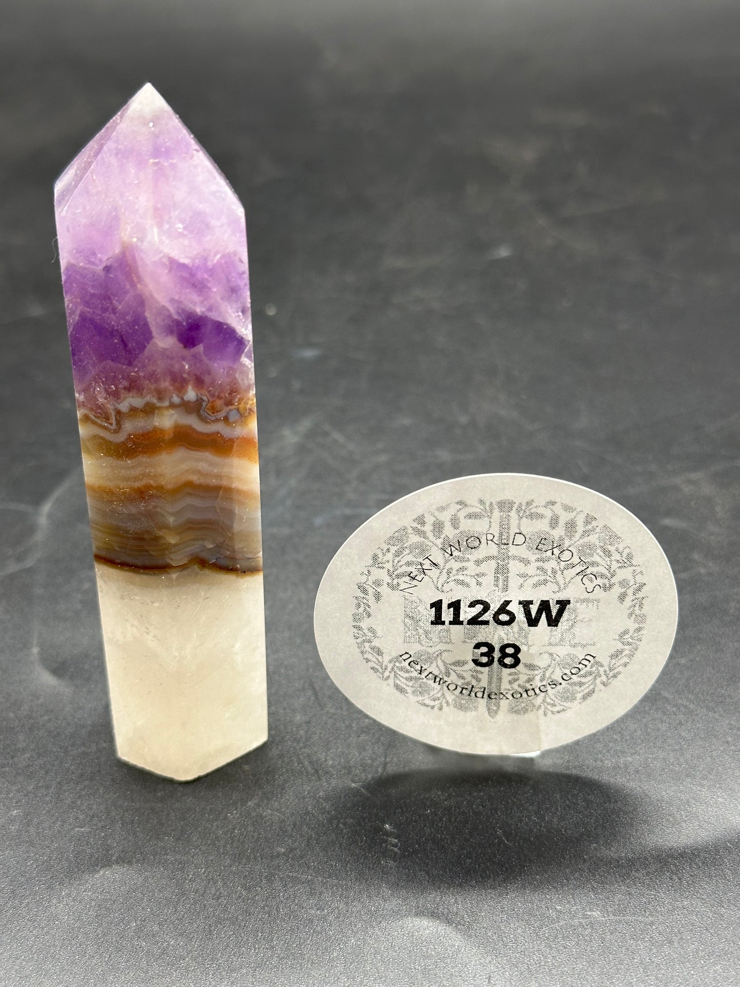 Amethyst Agate Tower (1126W38) with a round label and white sticker featuring black text, showcasing its unique crystal structure.