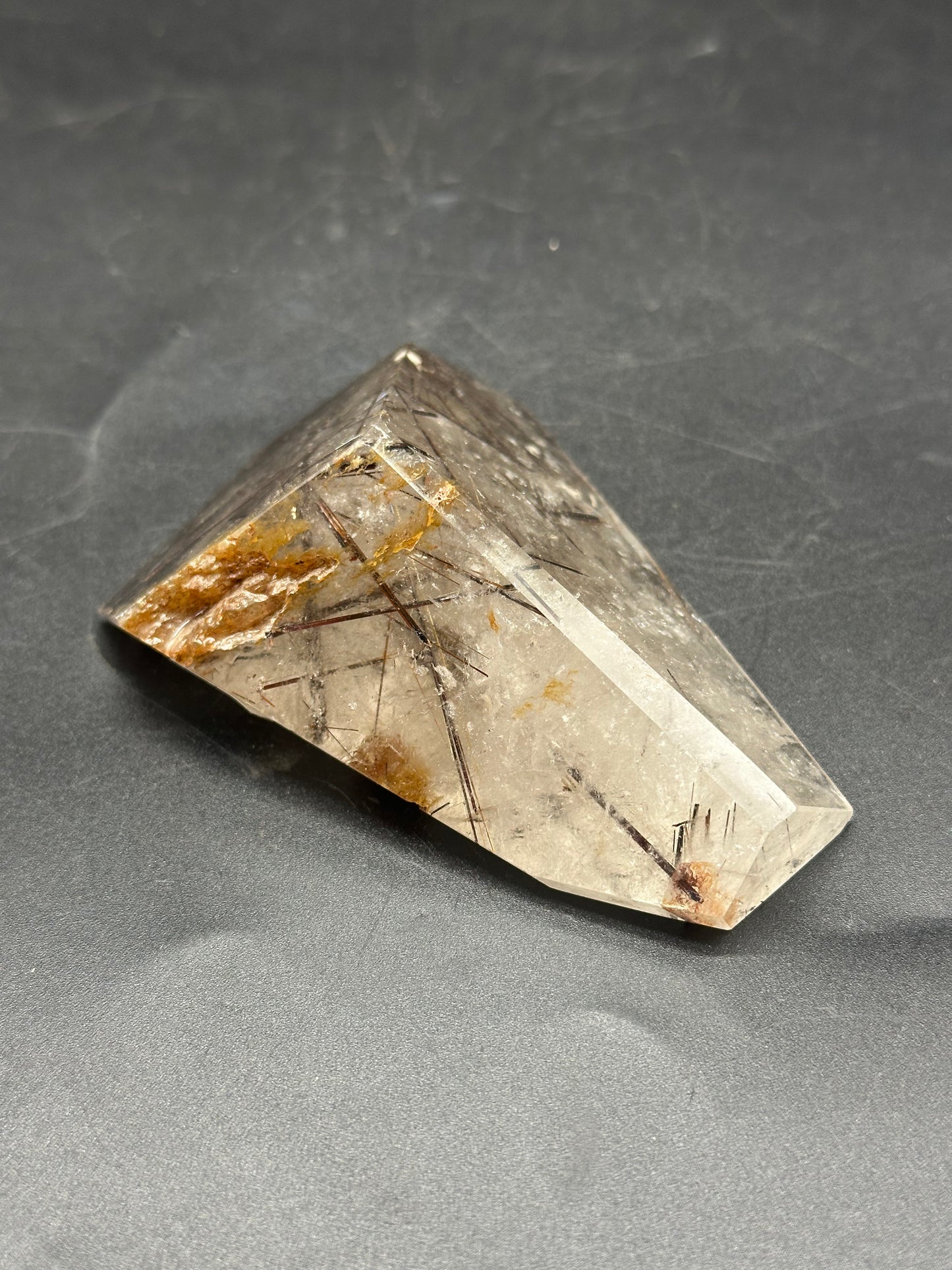 Black Rutilated Quartz (1212W25) featuring intricate black and brown crystal patterns, highlighted by a prominent quartz point, captured in a detailed close-up.