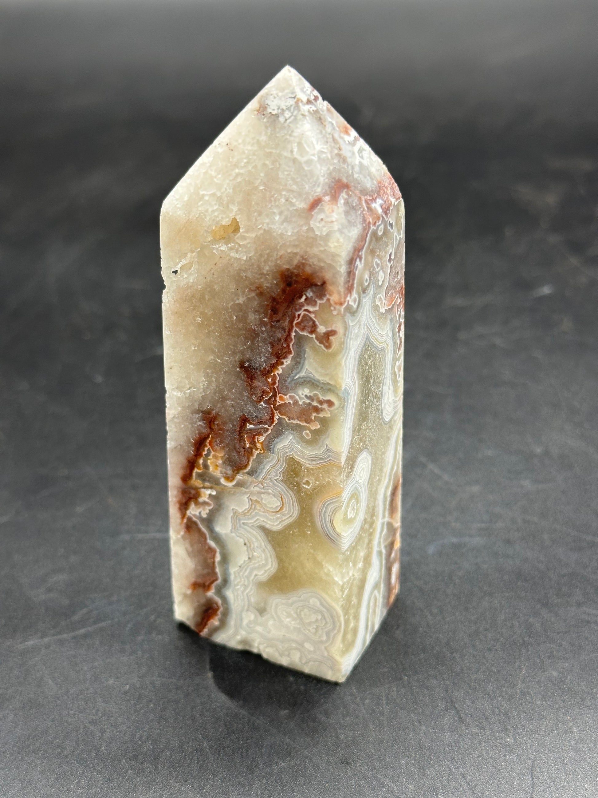 Close-up of Crazy Lace Agate Tower (1126W37), showcasing its intricate stone and mineral patterns.