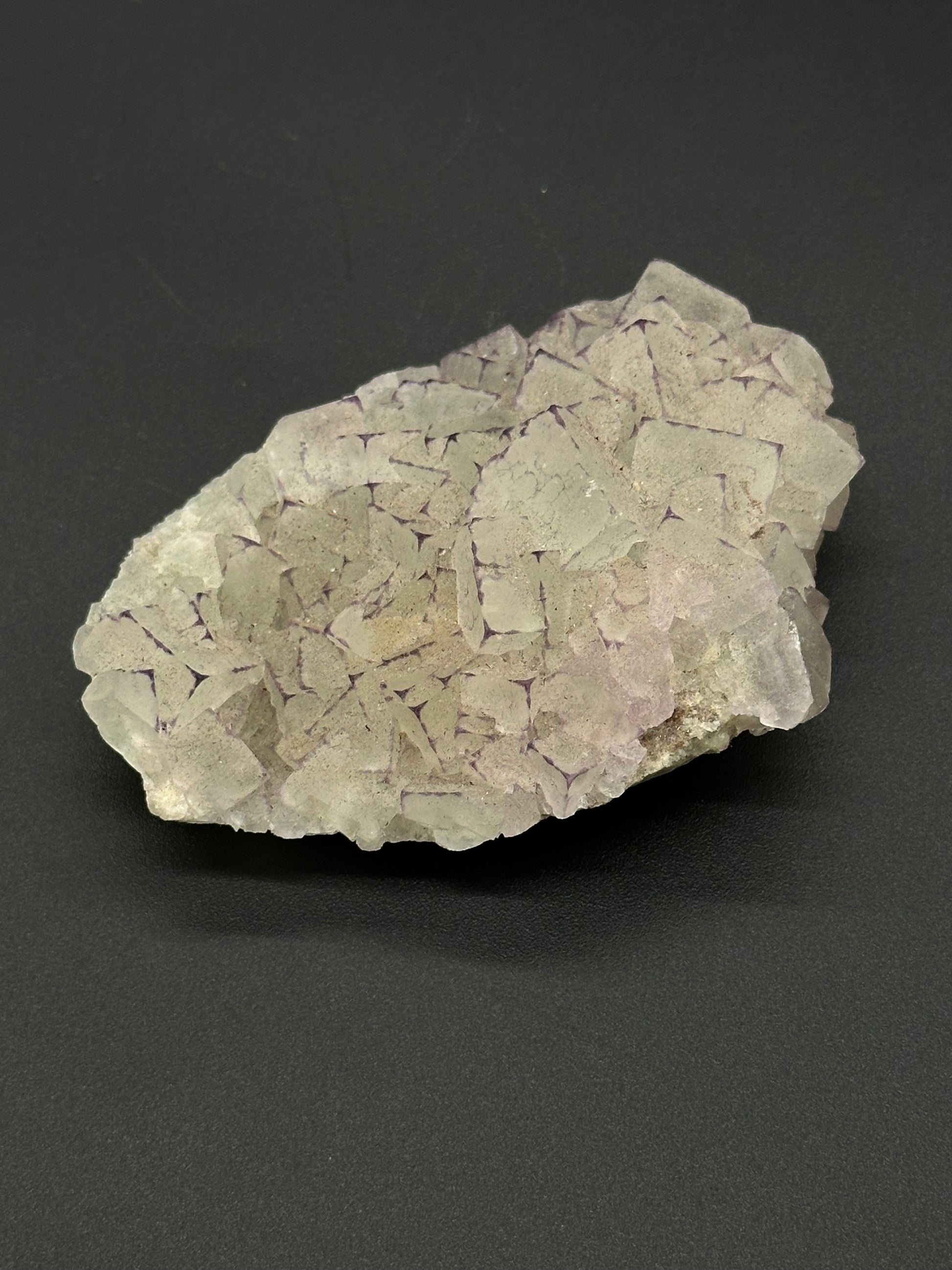 QR Code Fluorite (522W03), a natural mineral, 2.7 inches long, featuring UV reactive properties that enhance its intricate patterns.