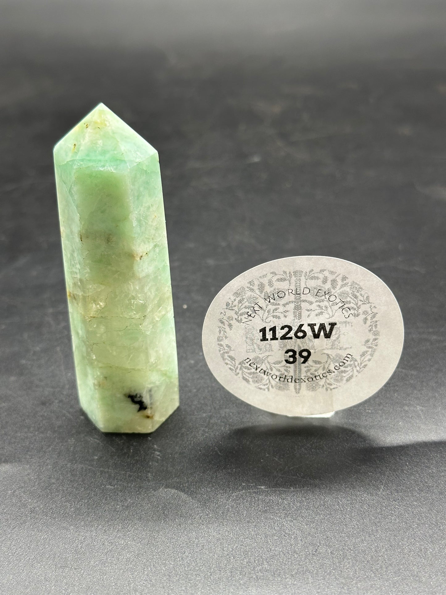 Quantum Quatro Tower (1126W39) featuring a distinct pointy shape, accompanied by a numbered sticker, showcasing its unique mineral properties.