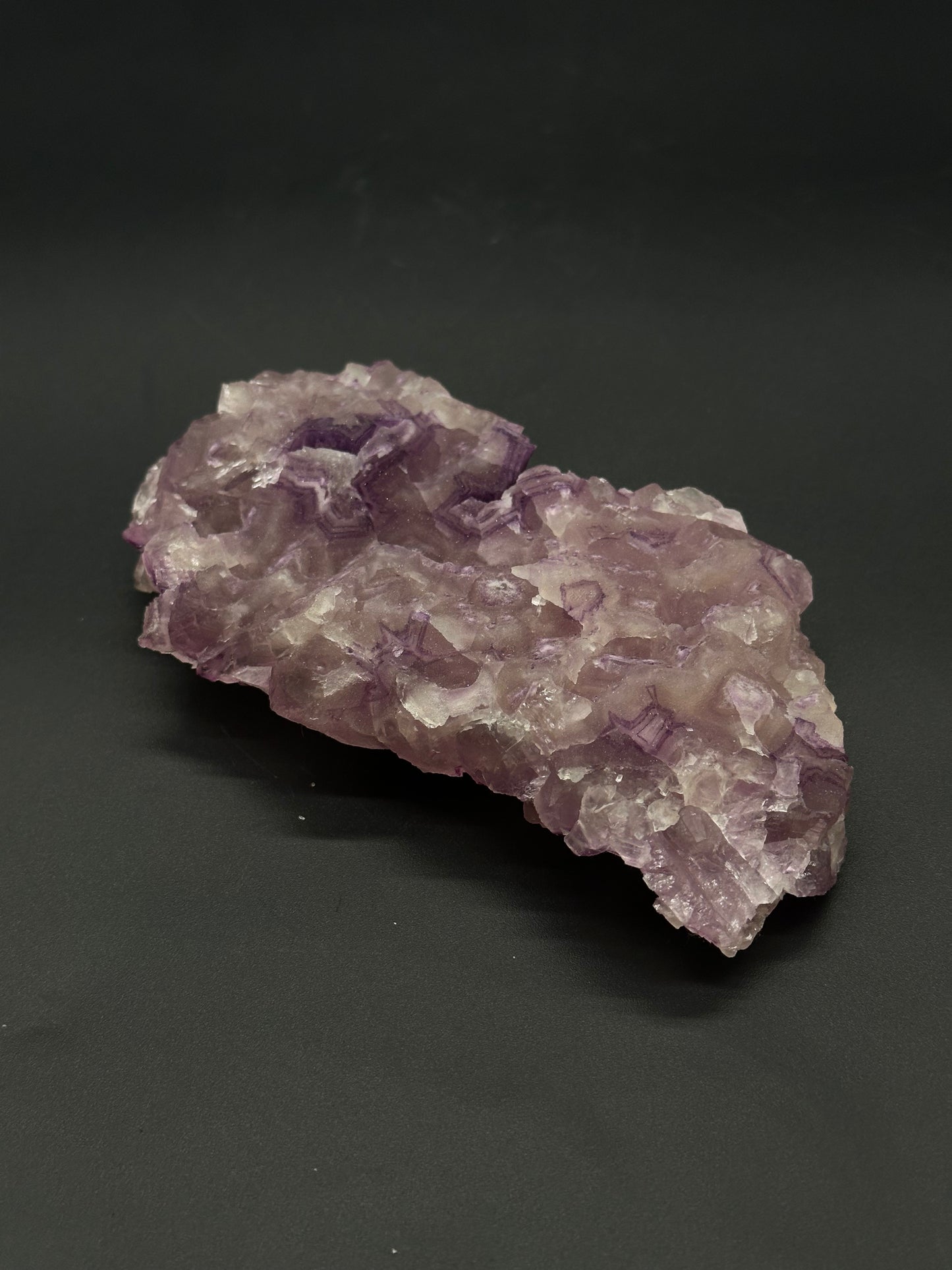 Raw Fluorite (515W02) mineral showcases natural, angular formations and a radiant, crystalline structure, highlighting its inherent geological beauty and distinct texture.