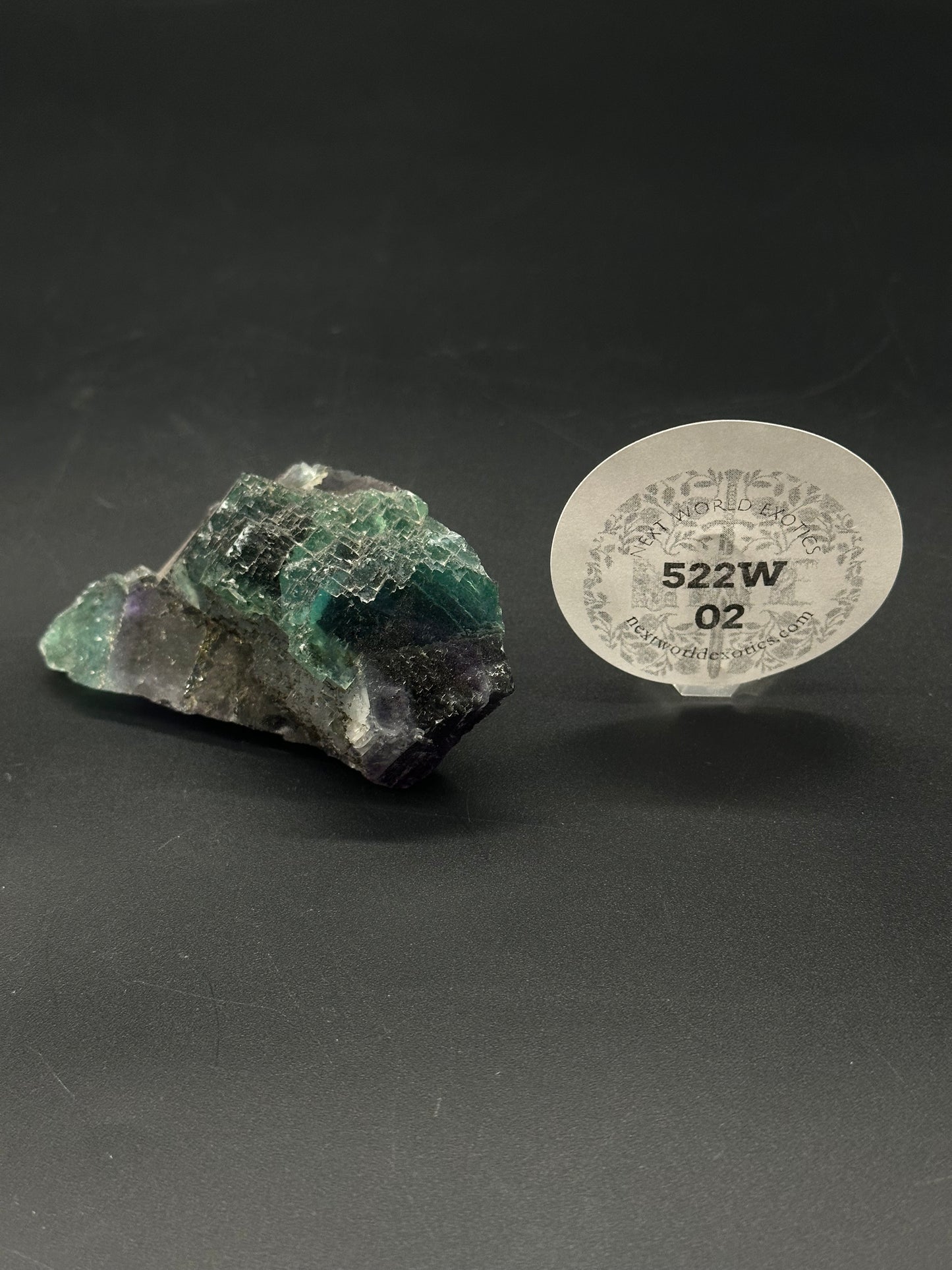 Raw Fluorite (522W02), a naturally formed mineral, displays unique geometric formations and translucent clarity, highlighting its raw, unpolished state.