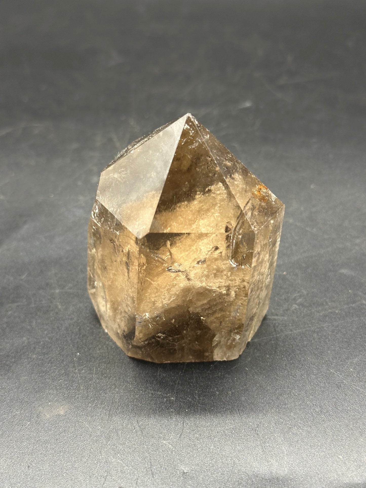 Smokey Garden Quartz (1212W22), a clear crystal with intricate formations, rests on a black surface, highlighting its mineral structure and natural beauty.