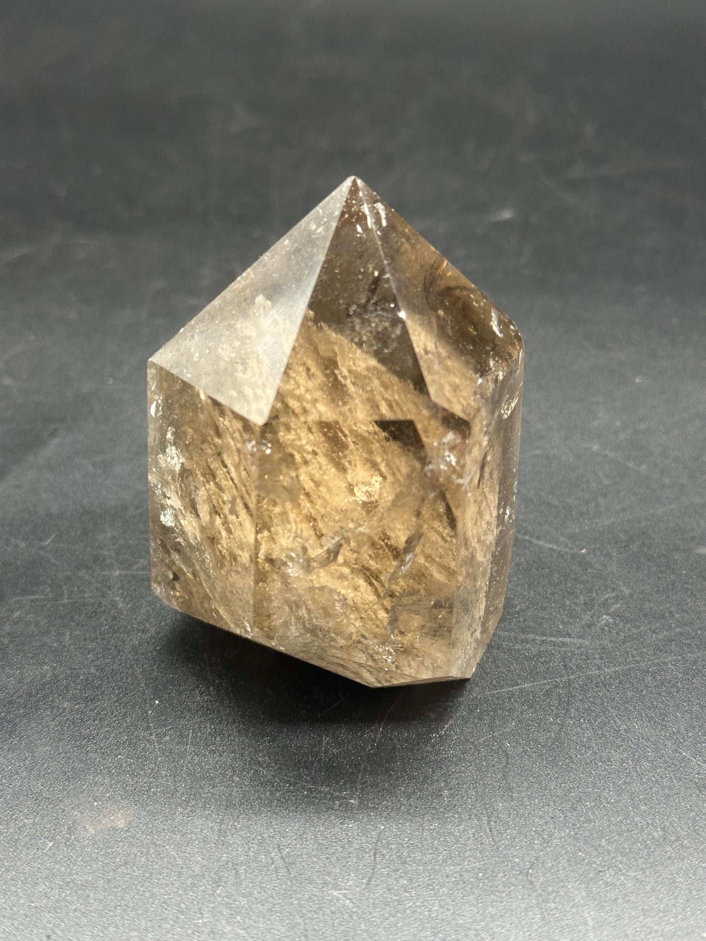 Smokey Garden Quartz (1212W22) crystal displayed on a black surface, showcasing its intricate, clear structure and natural mineral beauty.