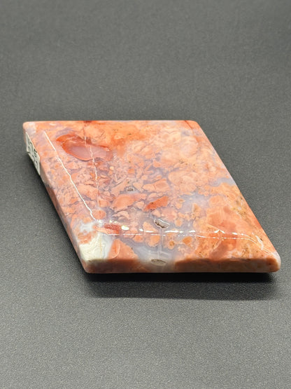 Pink Agate Faceted Diamond (213W04) showcasing its intricate, faceted surface resembling a polished, rectangular stone. Ideal for crystal or mineral enthusiasts.