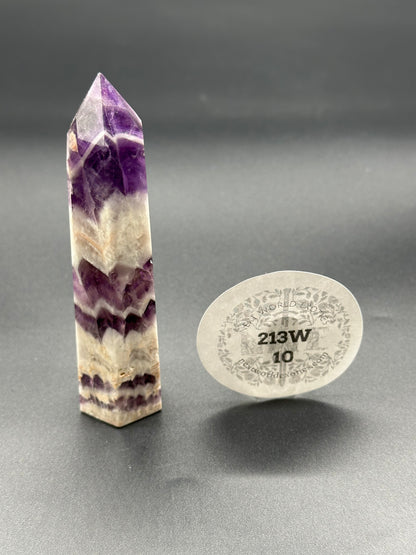 Dream Amethyst Tower (213W10) featuring a purple and white pointy stone, highlighted in close-up for detail, showcasing its crystal structure.