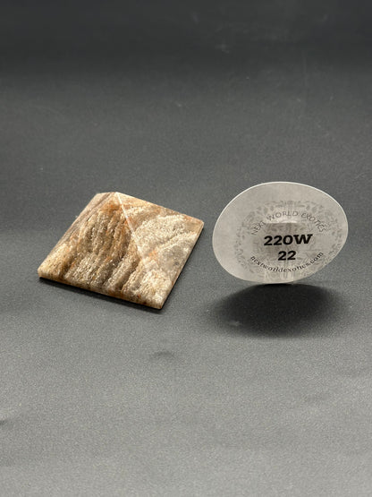 Thousand Layer Quartz Pyramid (220W22) close-up showing intricate stone layers and a label with text and numbers, emphasizing its detailed craftsmanship.