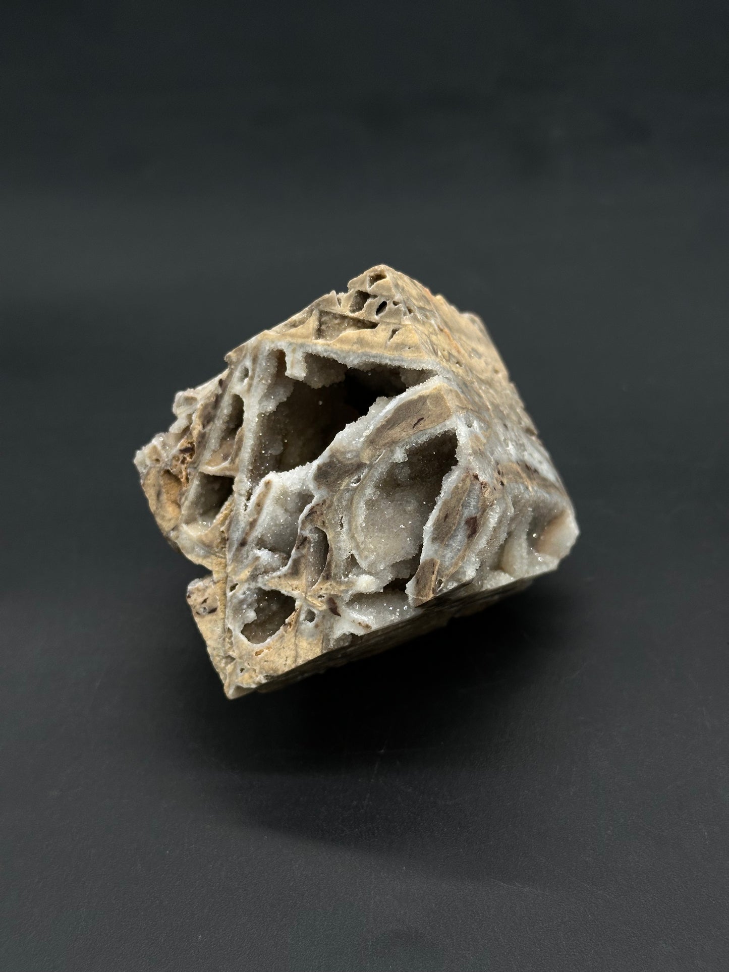 Sphalerite Cube (812W05) features a vuggy rock specimen with sparkling quartz crystals lining its cavities, resembling a broken-open geode or drusy quartz.