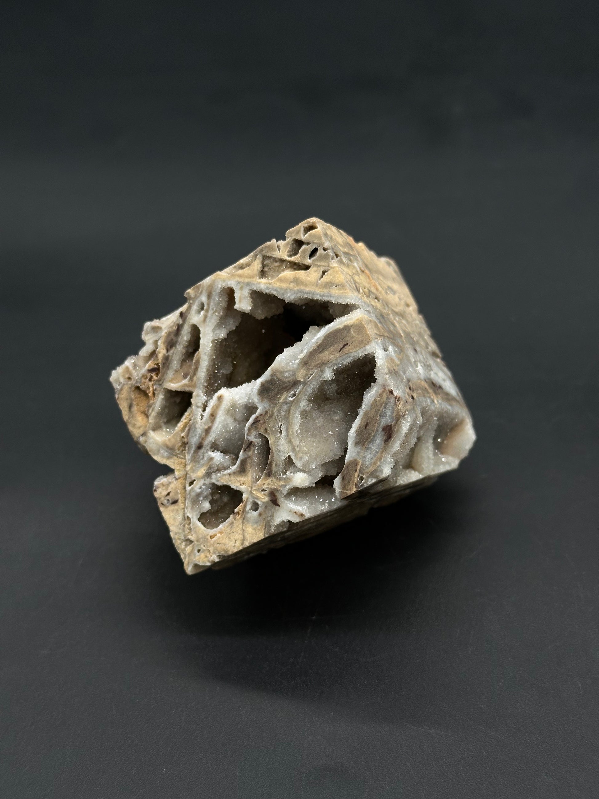 Sphalerite Cube (812W05) features a vuggy rock specimen with sparkling quartz crystals lining its cavities, resembling a broken-open geode or drusy quartz.
