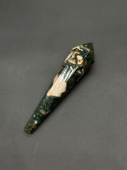 Red Moss Agate Scepter (812W12), a polished, faceted stone wand shaped as a hexagonal prism with a pointed tip, showcasing mottled jasper patterns.