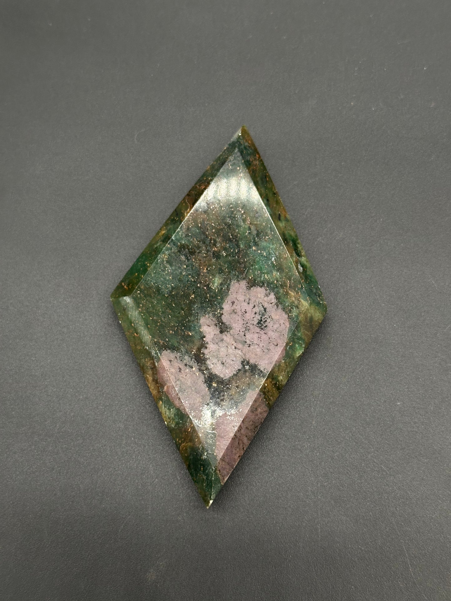 Ruby Kyanite Faceted Diamond (812W13) featuring a rhombus shape with a gem-cut pyramid face, displaying deep green hues and rose-pink patches.