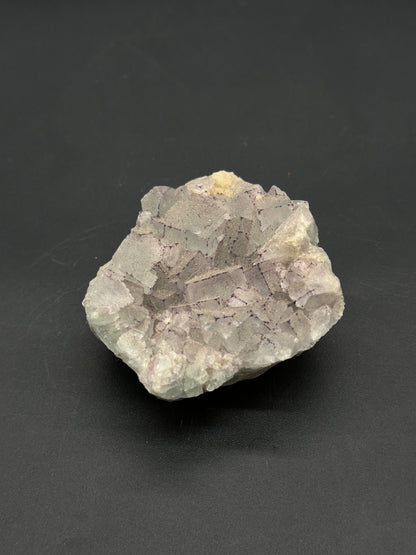 QR Code Fluorite (812W19) specimen with intergrown cubic crystals, showcasing distinctive zoning typical of fluorite, emphasizing its mineralogical features.