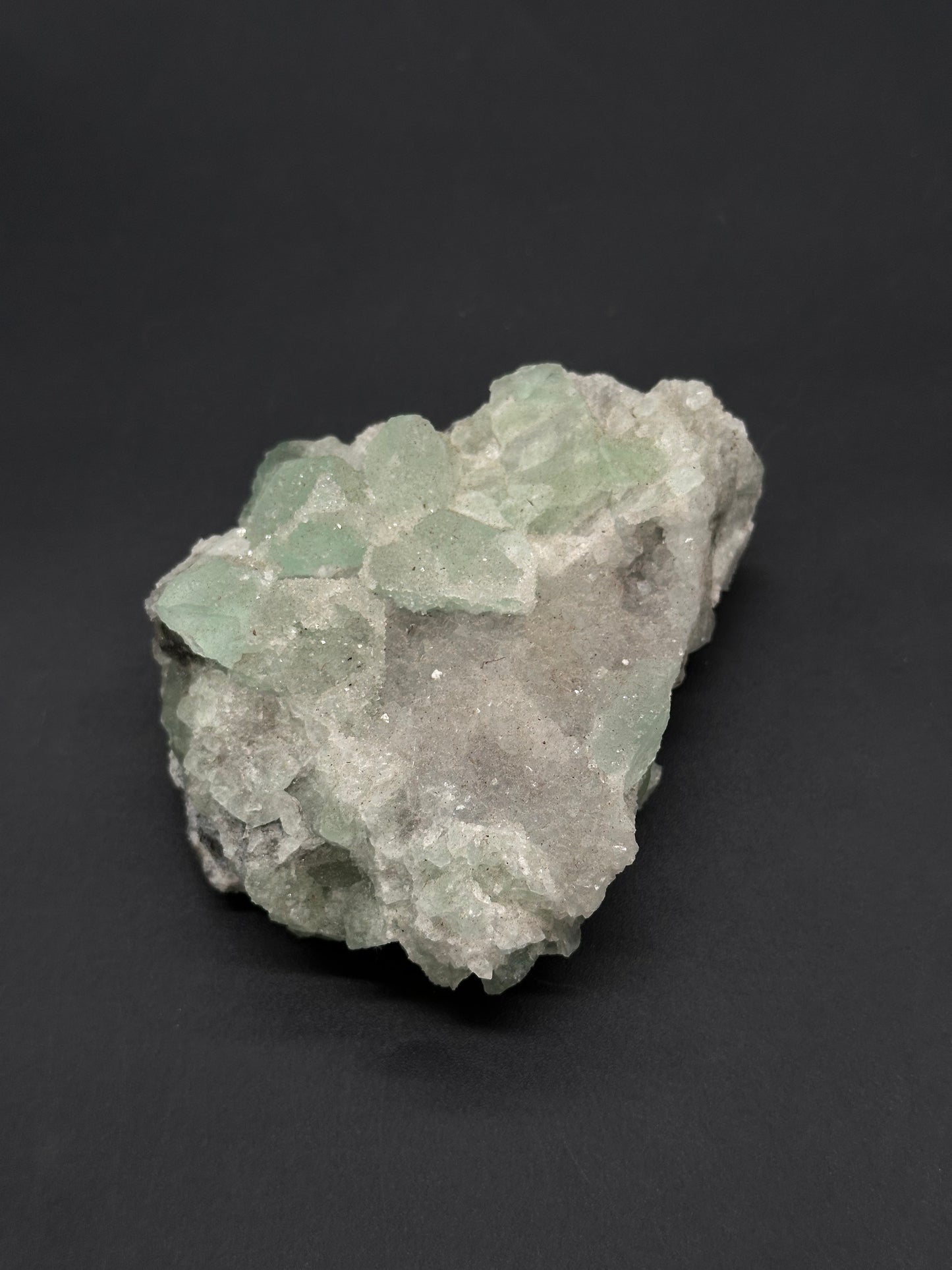 Sugar Fluorite (812W20) specimen featuring pale green, translucent crystal clusters with blocky, pyramidal shapes on gray-white host rock, sparkling in the light.