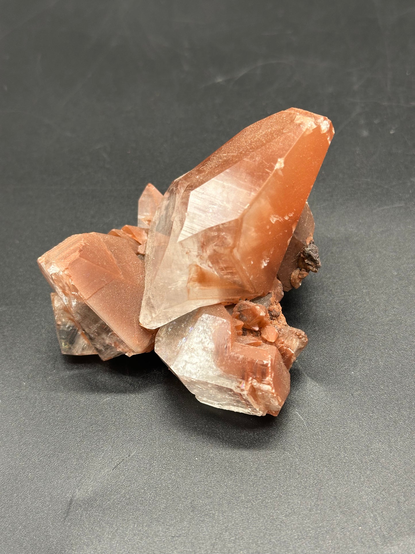 Close-up of Red Diamond Calcite (1114W10), showcasing its intricate crystalline structure against a neutral background, highlighting its natural mineral formation.