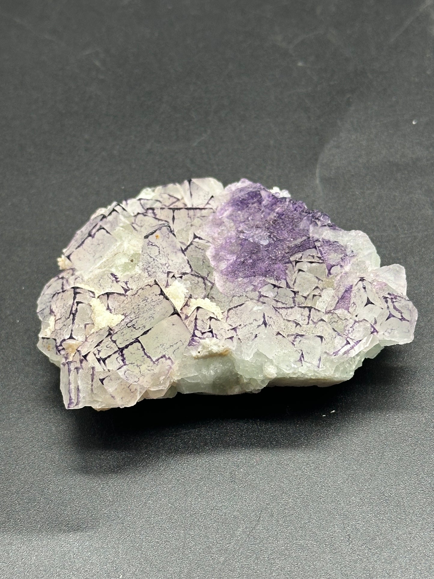 Close-up of QR Code Fluorite (1024W51), showcasing its intricate purple and white mineral formations.