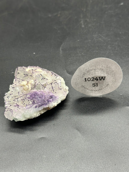 Close-up of QR Code Fluorite (1024W51) featuring a detailed mineral surface, showcasing intricate crystal formations and a visible sticker element.