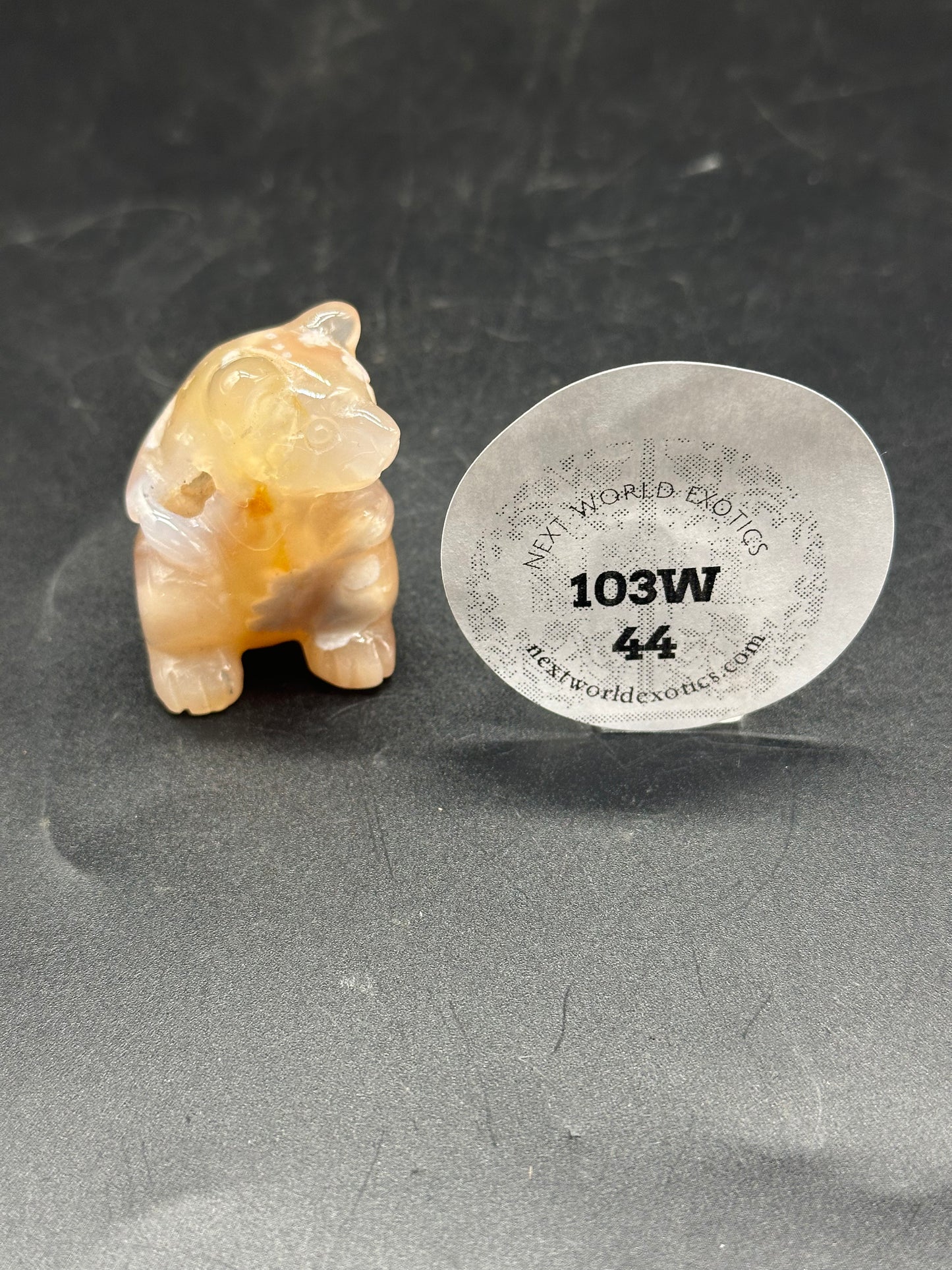 Agate Bear Carving (103W44): A detailed small figurine of a bear carved from agate, showcasing intricate craftsmanship and natural stone patterns.