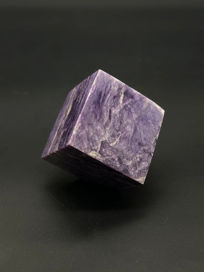 Charoite Cube (515W01): A polished charoite mineral cube showcasing intricate patterns and natural luster, suitable for collectors or as a decorative piece.