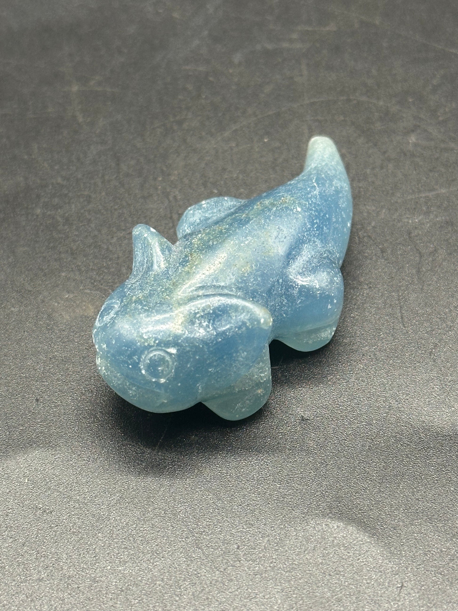 Labradorite Axolotl Carving (1212W27) featuring a detailed blue stone fish-like shape on a sleek surface, highlighting its unique crystal craftsmanship.