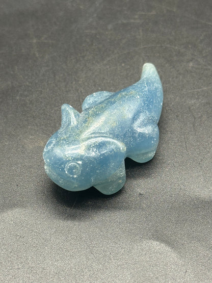 Labradorite Axolotl Carving (1212W27) featuring a detailed blue stone fish-like shape on a sleek surface, highlighting its unique crystal craftsmanship.