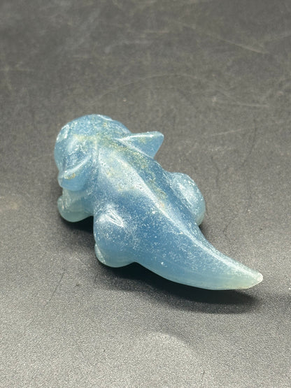 Labradorite Axolotl Carving (1212W27) depicting a lizard-shaped figure crafted from blue crystal, displayed on a dark surface.