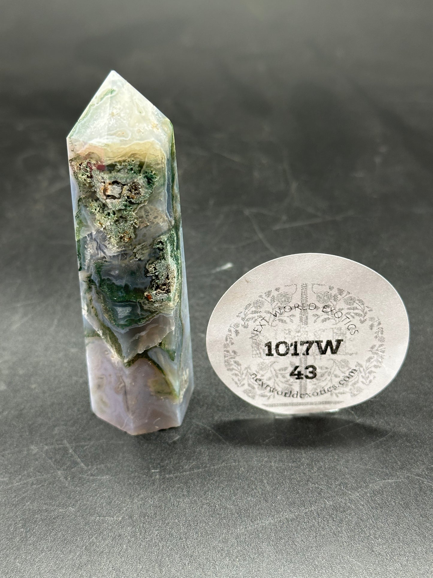 Moss Agate Tower (1017W43) alongside a round label featuring black text and numbers, highlighting details for identification and authenticity.