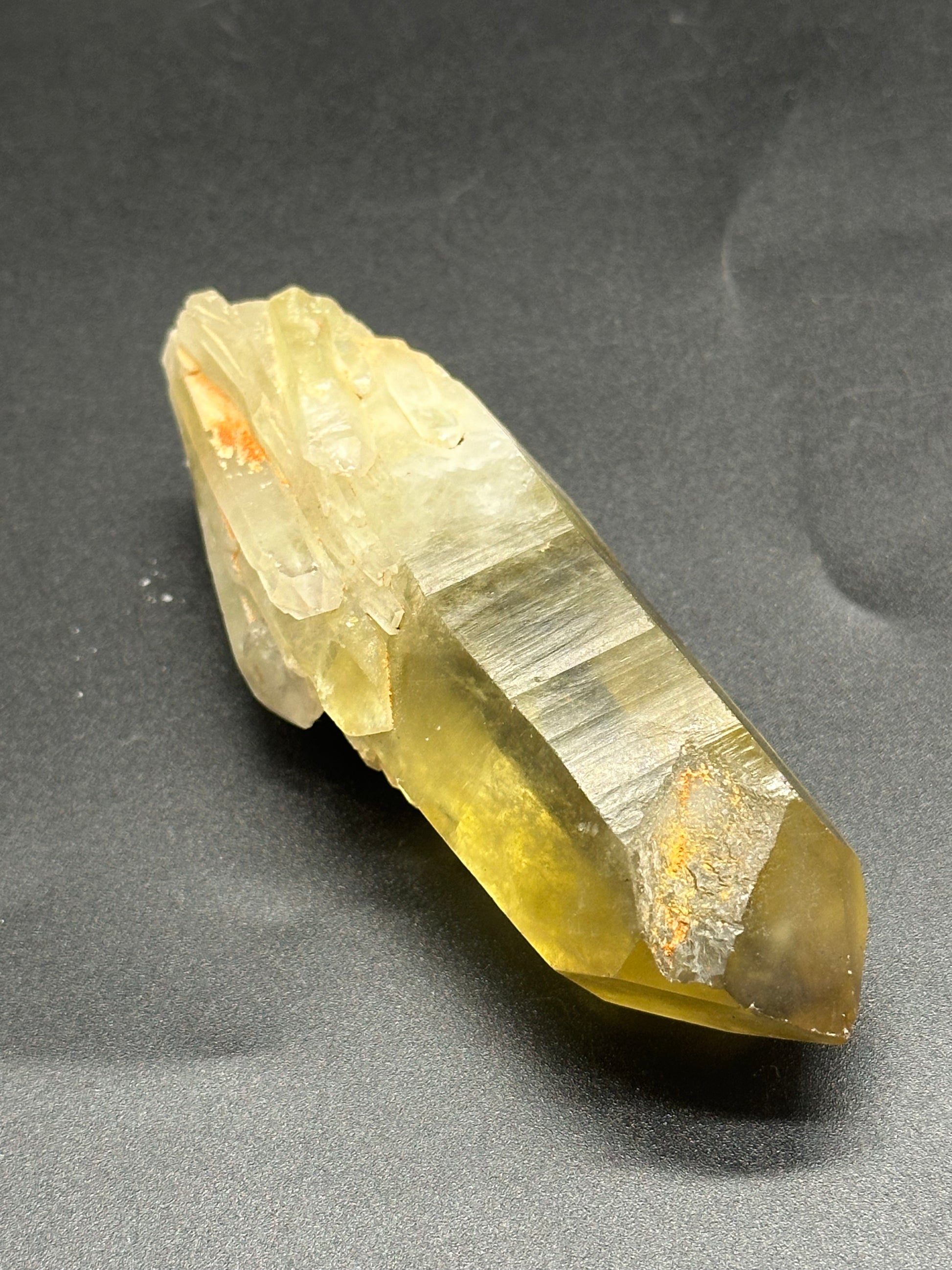 Natural Citrine, Raw (1024W48) crystal displayed on a dark surface, highlighting its raw, unpolished texture and unique mineral formations.