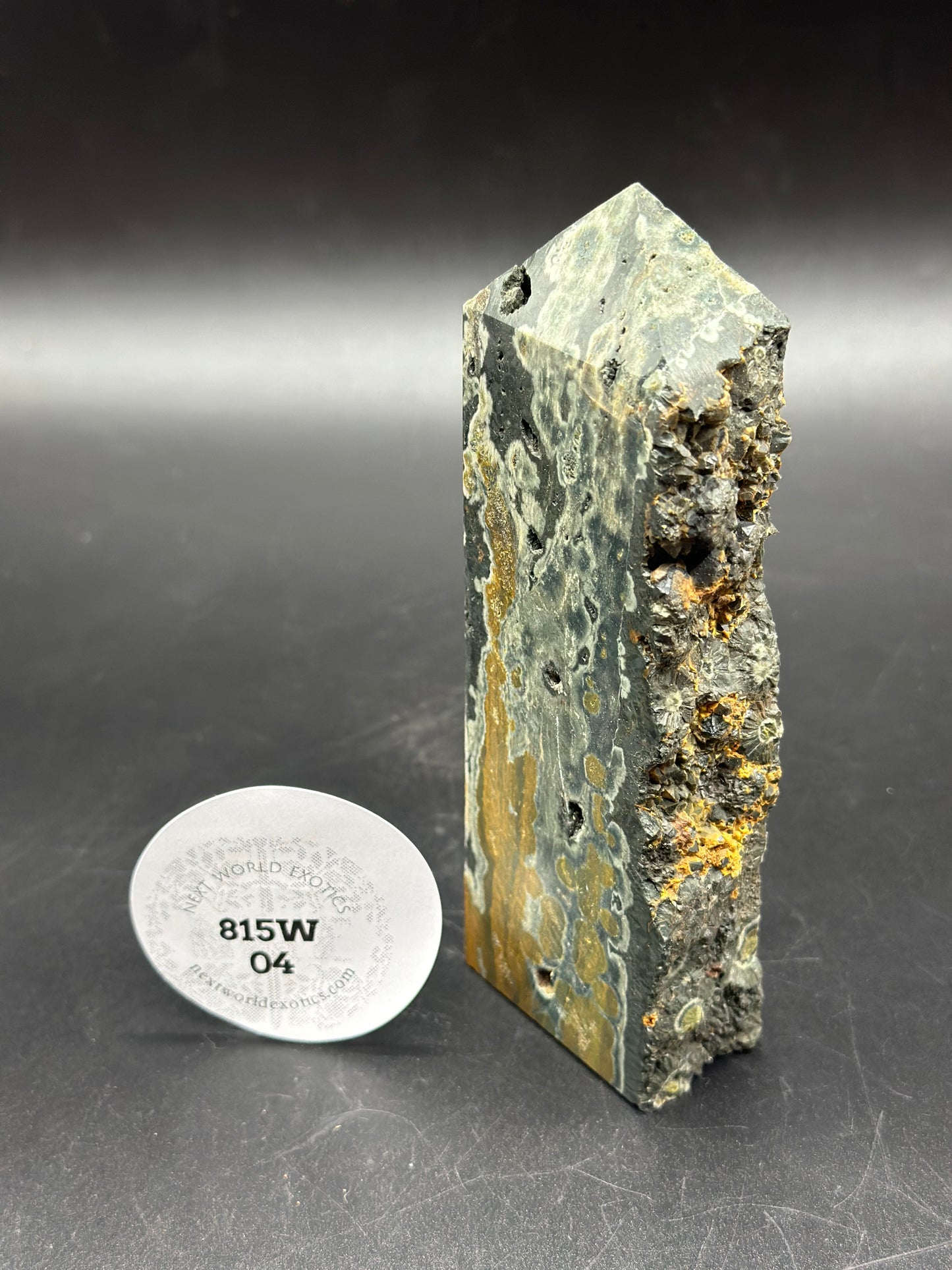 Ocean Jasper Tower (815W04) with a pointy design and intricate yellow and green patterns, featuring a visible label with black text.