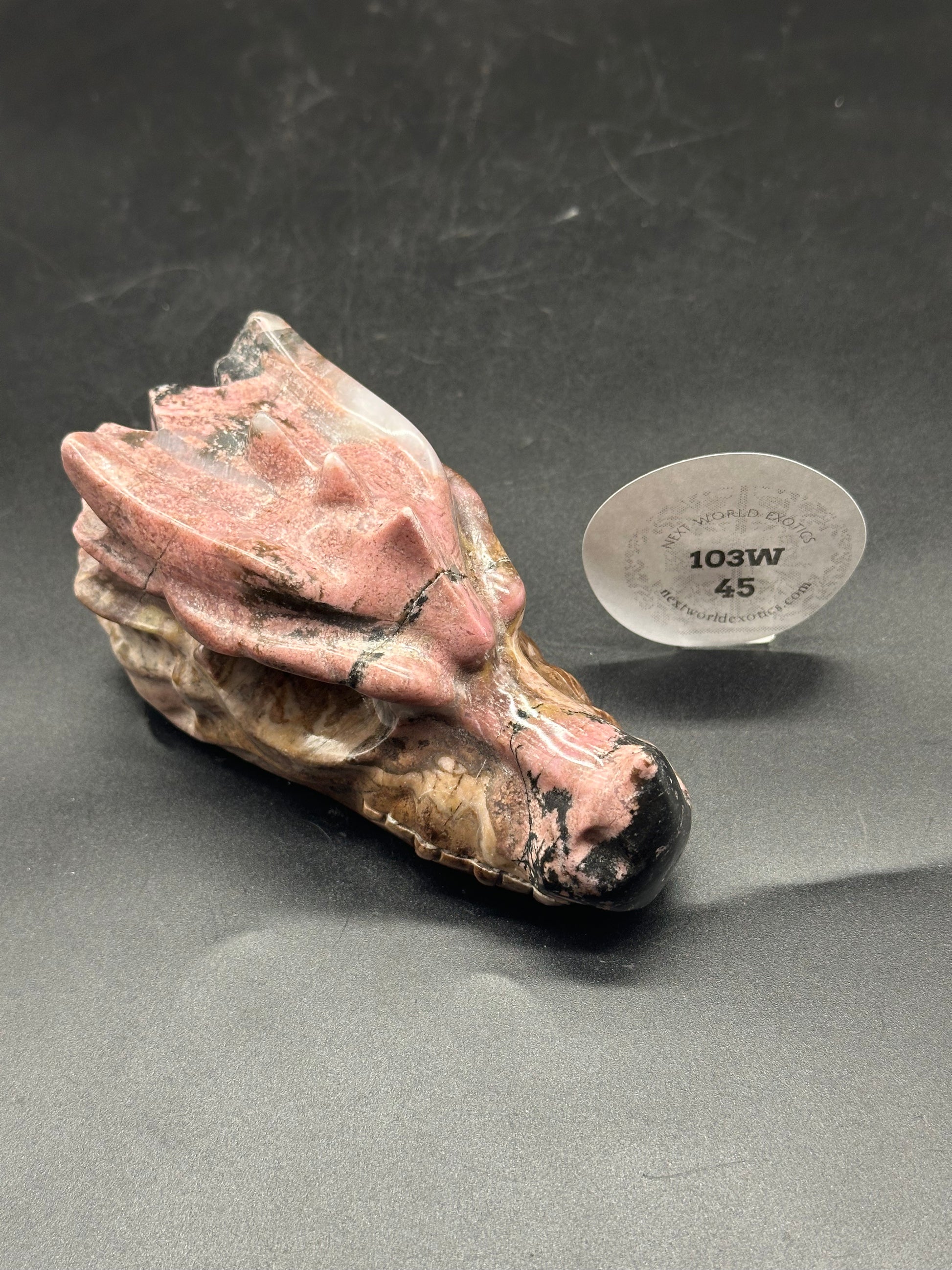 Pink Rhodonite Dragon Head (103W45) featuring intricate black speckled surface and detailed carving.