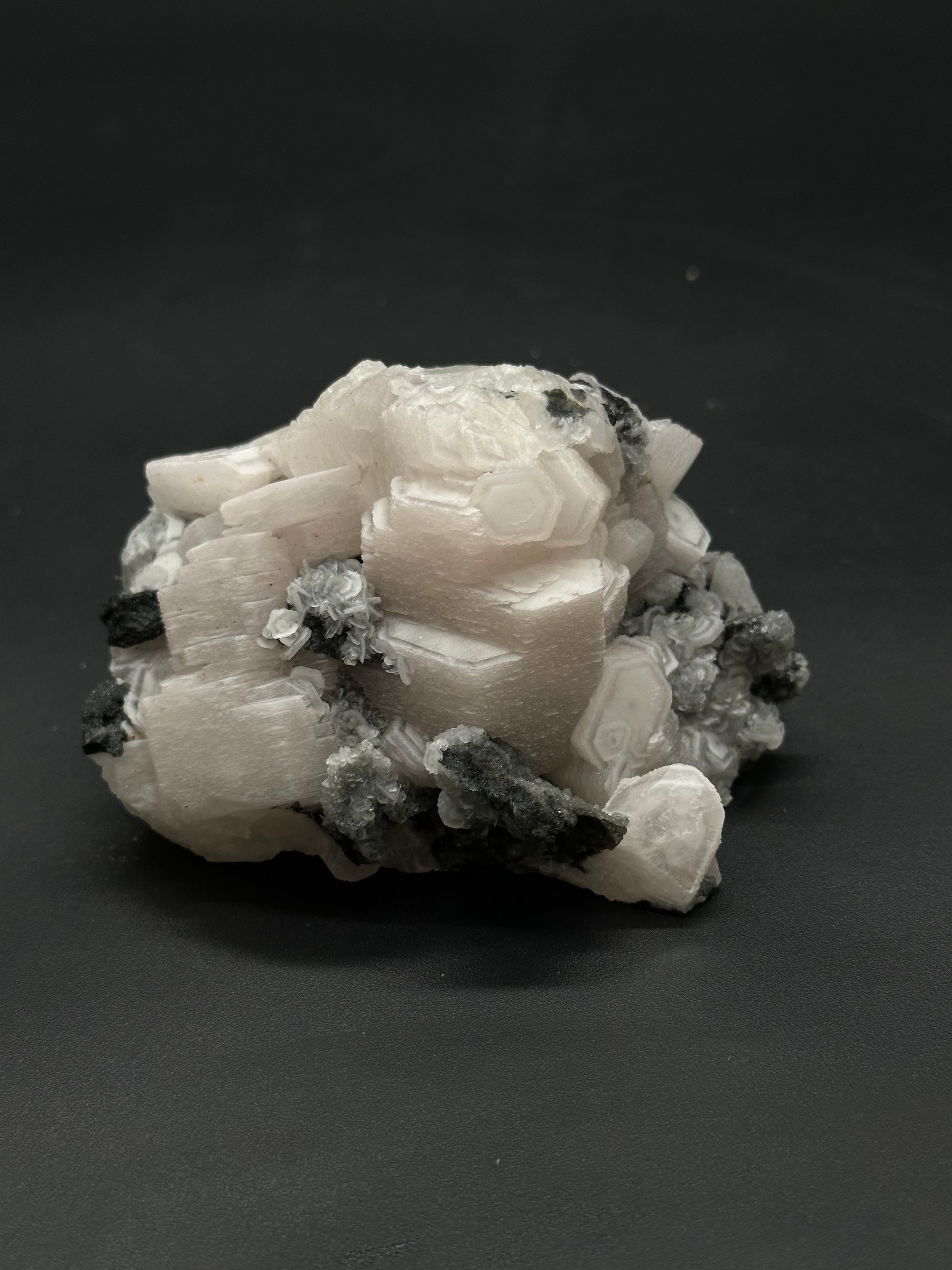 Raw Coin Calcite (508W28) displays a natural, unpolished surface, showcasing its organic texture and distinct mineral formations, perfect for enthusiasts and collectors.