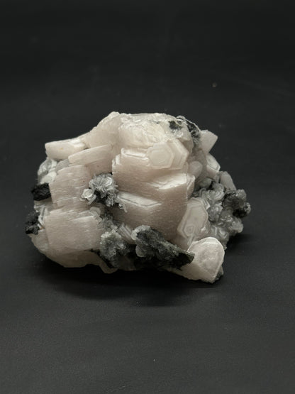 Raw Coin Calcite (508W28) displays a natural, unpolished surface, showcasing its organic texture and distinct mineral formations, perfect for enthusiasts and collectors.