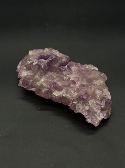 Raw Fluorite (515W02) mineral showcases natural, angular formations and a radiant, crystalline structure, highlighting its inherent geological beauty and distinct texture.