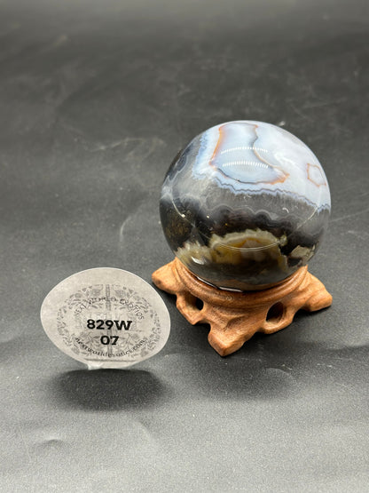 Volcanic Agate Sphere (829W07) displayed on a stand.