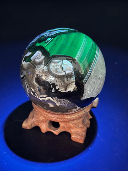 Volcanic Agate Sphere (1126W31) displayed on a stand, showcasing its intricate surface patterns and smooth, polished finish.