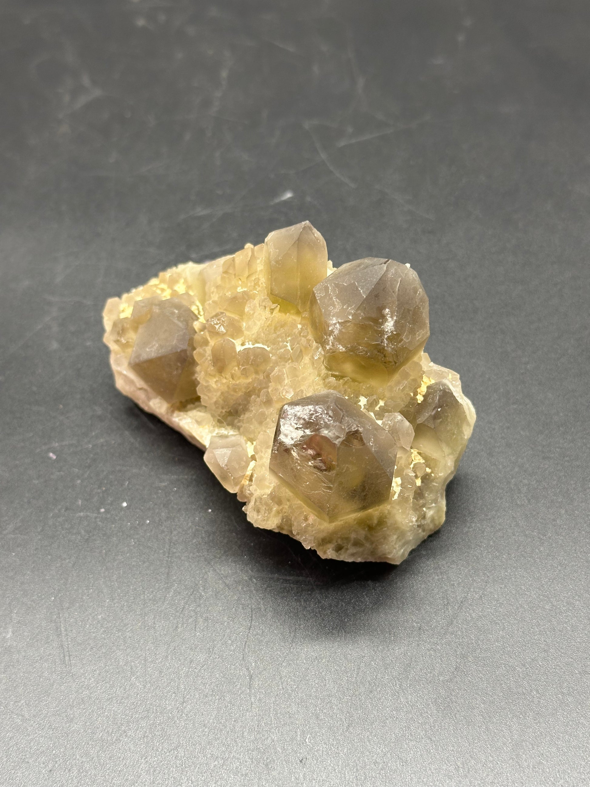 Close-up of Yellow Pineapple Cluster Quartz (1017W51), showcasing intricate crystal formations on a rock surface, emphasizing its mineral structure.